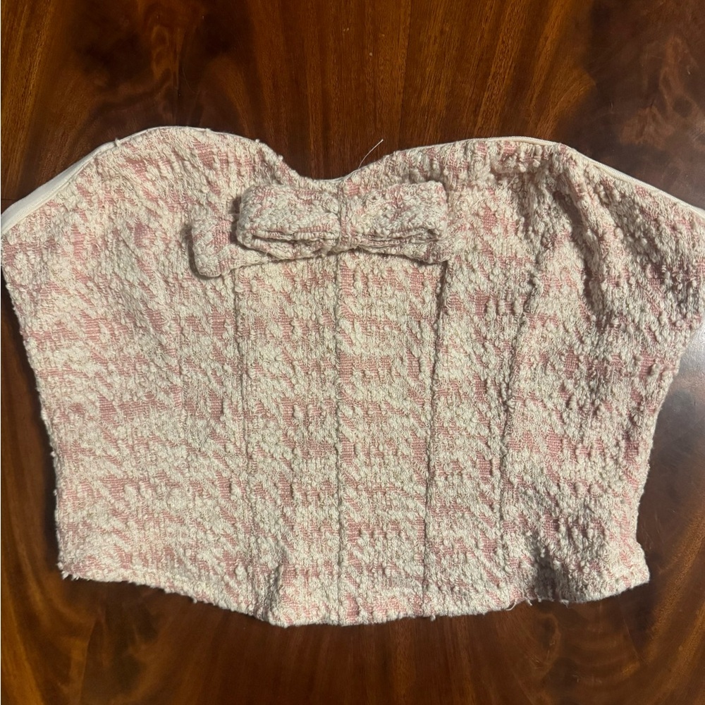 Altar'd State pink tweed corset top featuring a bow detail.